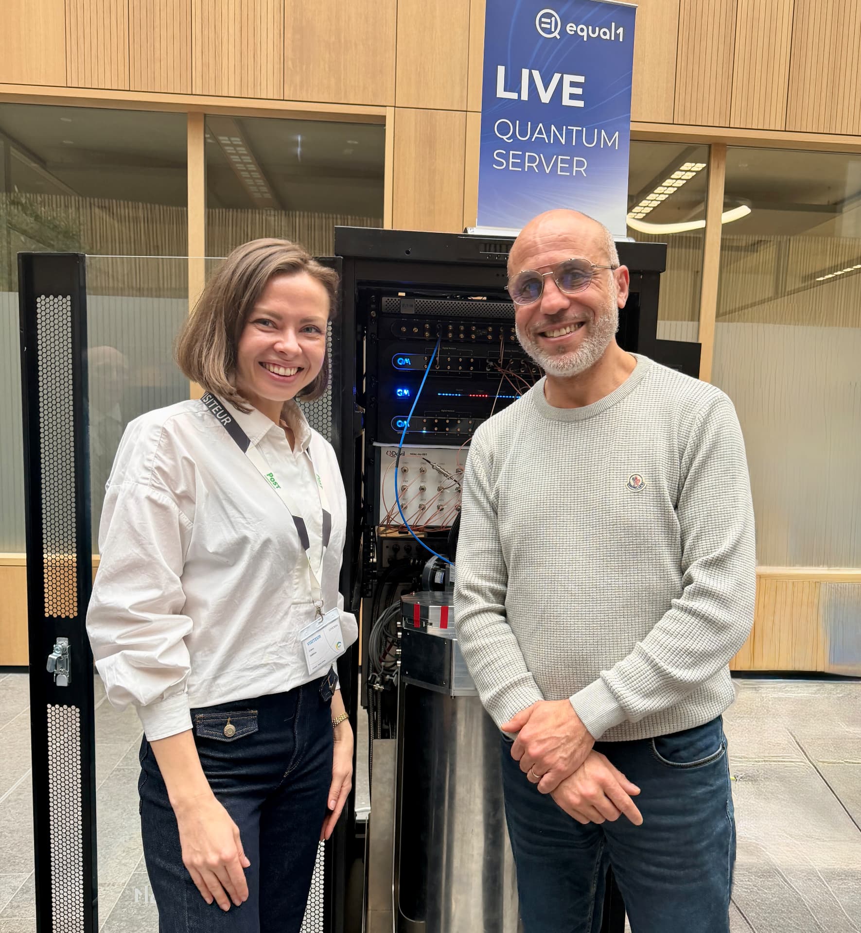 Liene Daktina beside a live quantum server exhibit