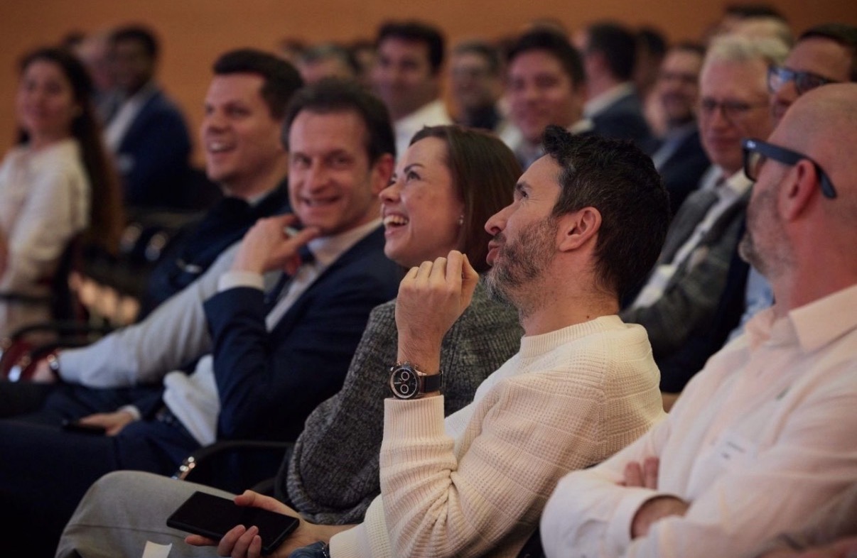 Audience laughing at a conference session