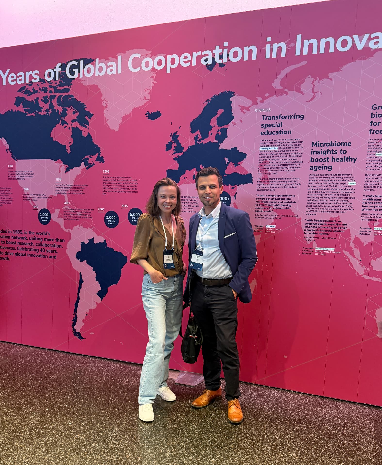 Liene Daktina with a colleague at the Eureka anniversary wall